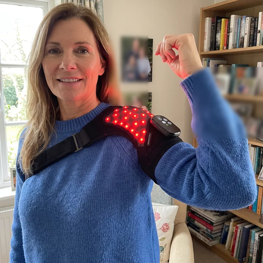 Michelle, 47, wearing the Ostrane Ember red light shoulder wrap at home